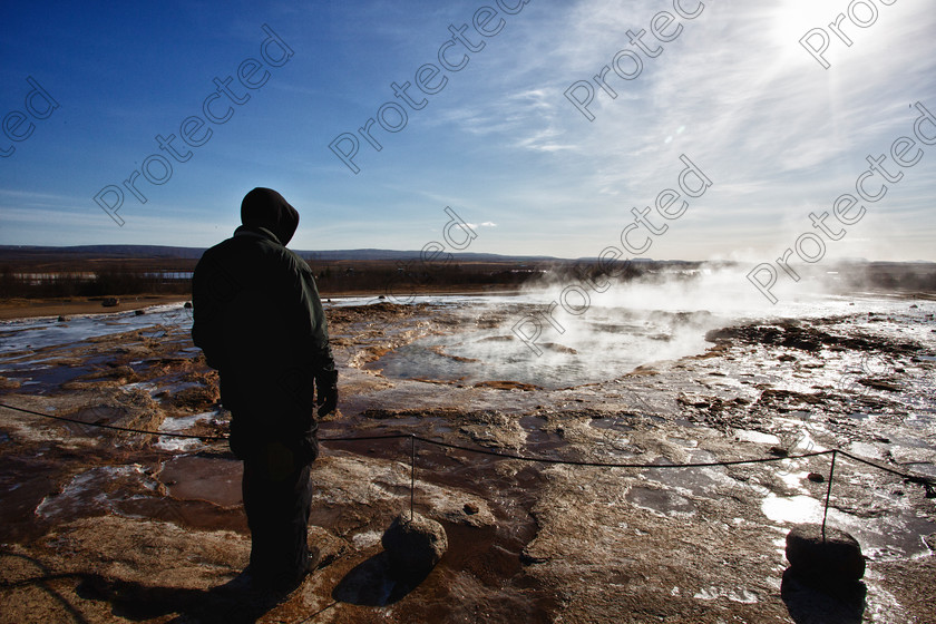 0724 Geysir full res 
 Man waiting for geyser eruption 
 Keywords: Men, Silhouette, Strokkur, Geyser, Iceland, Heat, Spring, Water, Blue, Turquoise, Hot Spring, Northern Europe, haukadalur, Nordic Countries, Steam, Mountain Range, Landscape, Nature, Sulphur Spring, Volcanic Terrain, Central Iceland, Vacations, Travel Destinations, No People, Tourism, Travel, Geology, Outdoors