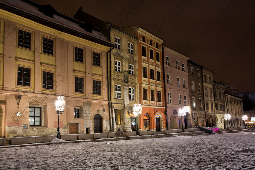 6H1C0213 
 Small Market in Krakow during winter at night 
 Keywords: architecture, basilica, beautiful, boutique, building, cathedral, church, city, cloud, color, colorful, cracow, day, europe, facade, famous, front, historic, hotel, house, krakow, landmark, main, mariacki, market, old, people, poland, polish, restaurant, roof, shop, side, sky, small, square, statue, street, sun, sunny, tourism, tourist, town, travel, unesco, urban, view, white, window, winter, snow, night