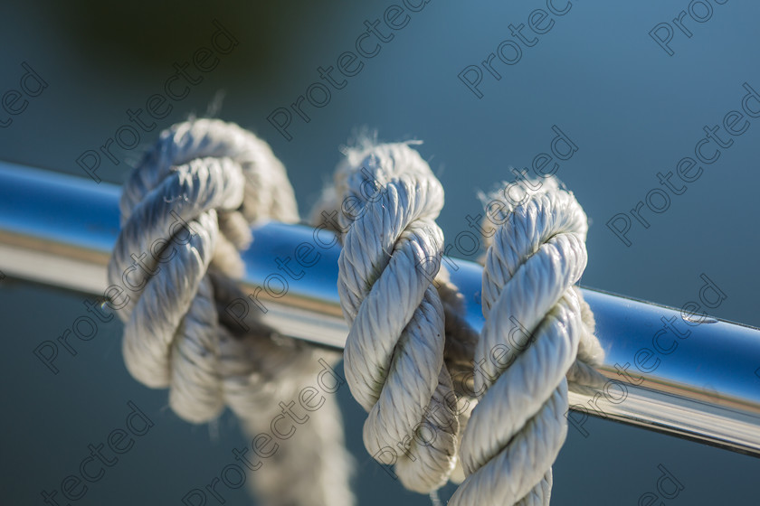 6H1C1595-Edit 
 Rope on boat 
 Keywords: rope, boating, boat, detail, yachting, yacht, nautical, nautic, closeup, cruise, steel, cord, deck, travel, power, winch, ship, equipment, recreation, transport, sailboat, maritime, marine, moored, sea, vessel, metal, ocean, twisted, white, regatta, tying, close-up, rigging, object, attached, blue, sail, water, knot