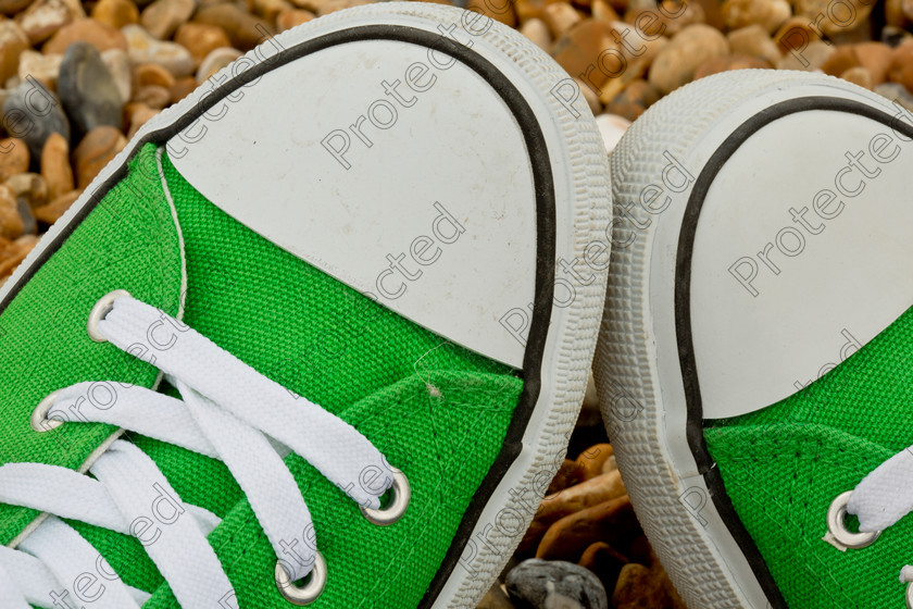 Summer-shoes-002 
 Green sneakers against pebble background 
 Keywords: Animal Trainer, Coach, Instructor, Footwear, Grass, Green, Urban Scene, City Life, Fashion, White, Sport, Funky, Youth Culture, Cool, Modern, Fashionable, Lifestyles, Textured Effect, Spring, Moving Up, Label, Freedom, Pair, Foot, Rubber, Child, Close-Up, Beach, Stone, Stone, Pebble, New