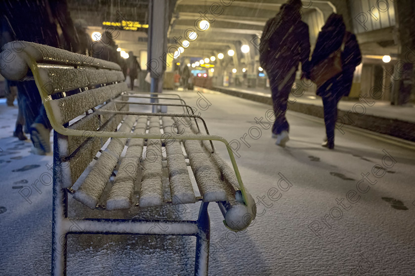 6H1C1590 
 Unrecognisable people walking on platform in winter 
 Keywords: cold, unrecognizable, winter, waiting, bench, outdoors, transportation, station, walking, snow, nature, people, train, season, construction frame, railroad track, railroad station platform