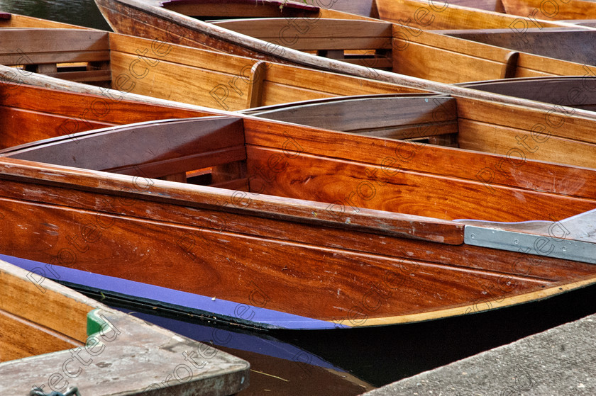 DSC 0098-2 
 Punts in Cambridge 
 Keywords: boat, cambridge, day, england, iconic, nobody, outdoors, punt, river, transport, vertical, water, wooden
