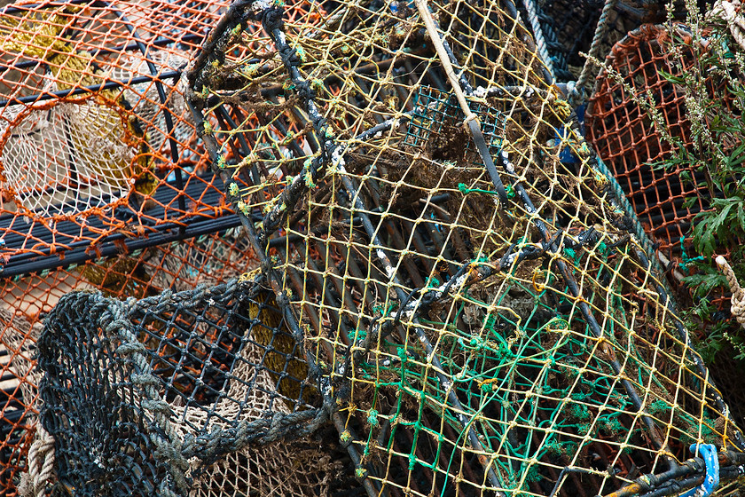 UK Norfolk DSC 0221 
 Stack of lobster fishing baskets in Wells-next-the-sea, North Norfolk coast 
 Keywords: basket, bay, beach, blue, boat, britain, british, catch, coast, coastal, crab, England, english, fish, fishery, fishing, food, industry, lobster, marine, net, Norfolk, old, sea, seafood, seaside, trap, uk, water