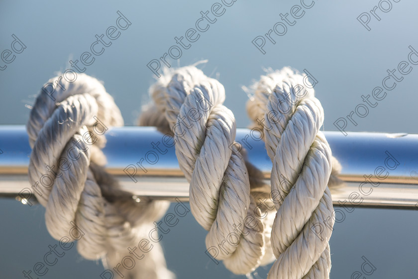 Rope-001 
 Keywords: rope, boating, boat, detail, yachting, yacht, nautical, nautic, closeup, cruise, steel, cord, deck, travel, power, winch, ship, equipment, recreation, transport, sailboat, maritime, marine, moored, sea, vessel, metal, ocean, twisted, white, regatta, tying, close-up, rigging, object, attached, blue, sail, water, knot
