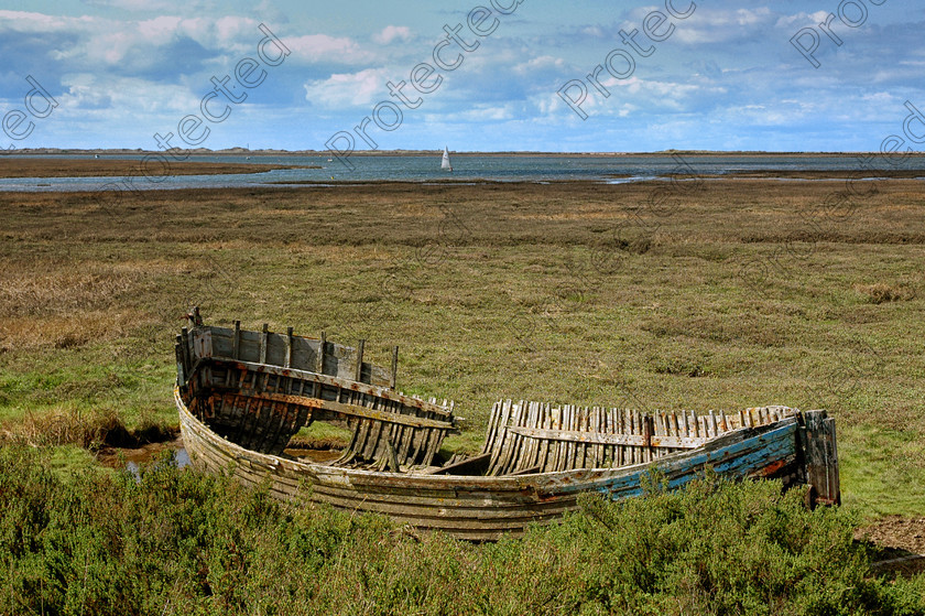 DSC 0274 
 Wreck of an abandoned fishing boat on the Blakeney marshes in Norfolk England 
 Keywords: abandoned, blakeney, boat, east anglia., fishing, low tide, mud flats, north norfolk, ocean, quay, salt marshes, sand, sea, stranded, water